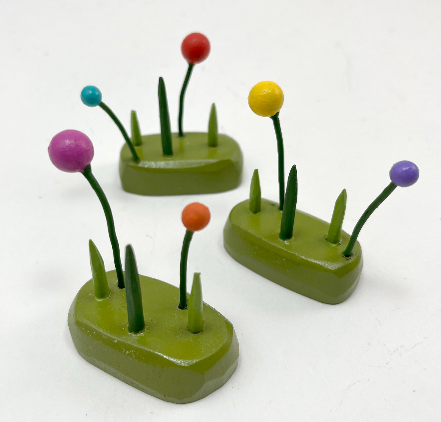 three tiny tufts of grass